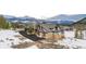 Stunning mountain home featuring stone accents, a three-car garage, and breathtaking snowy mountain views at 174 Sage Dr, Breckenridge, CO 80424