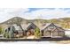 Beautiful exterior showcasing a well-maintained lawn, a stone facade, and an attached three-car garage at 174 Sage Dr, Breckenridge, CO 80424