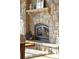 Close-up of a stone fireplace with a mantel, hearth, and an iron fire screen at 174 Sage Dr, Breckenridge, CO 80424