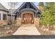Inviting front entrance featuring a stone pathway, columns, a wooden door, and rocking chairs at 174 Sage Dr, Breckenridge, CO 80424
