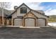 Spacious three-car garage featuring stone accents and elegant doors at 174 Sage Dr, Breckenridge, CO 80424