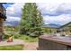 Scenic shot of an outdoor hot tub with a stone patio, firepit, and mountain views at 174 Sage Dr, Breckenridge, CO 80424