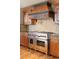 Gourmet kitchen featuring a Wolf range, granite counters, custom cabinetry, and decorative backsplash at 174 Sage Dr, Breckenridge, CO 80424