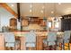 Kitchen island featuring wooden cabinets, granite countertops, and barstool seating at 174 Sage Dr, Breckenridge, CO 80424