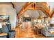 Open-concept living area with wooden beams, an island, and hardwood floors at 174 Sage Dr, Breckenridge, CO 80424