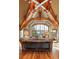 Bright living room with vaulted ceilings, exposed beams, and a large window overlooking snowy mountains at 174 Sage Dr, Breckenridge, CO 80424