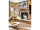 Cozy living room showcasing a stone fireplace with a mounted television above it at 174 Sage Dr, Breckenridge, CO 80424