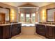 Luxurious main bathroom with a soaking tub, dual vanities, and scenic window views at 174 Sage Dr, Breckenridge, CO 80424
