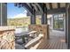 Inviting covered deck featuring a picnic table, stone accents, and scenic mountain views at 174 Sage Dr, Breckenridge, CO 80424