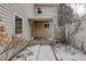 Cozy back patio with a covered porch and snow-covered walkway, great for outdoor relaxation at 2466 S Vaughn Way # A, Aurora, CO 80014