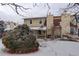 Exterior view of backyard with a patio and snow-covered ground at 2466 S Vaughn Way # A, Aurora, CO 80014