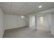 This is an empty basement space with neutral carpeting, white walls, and a partially finished area at 2466 S Vaughn Way # A, Aurora, CO 80014