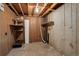 Unfinished basement featuring exposed ceiling, duct work, wood paneling, and concrete walls at 2466 S Vaughn Way # A, Aurora, CO 80014