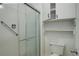 Bathroom with shower stall with grab bar and updated cabinets above toilet at 2466 S Vaughn Way # A, Aurora, CO 80014