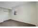 This empty bedroom features tan carpeting, a built in closet, and bright natural light from the window at 2466 S Vaughn Way # A, Aurora, CO 80014