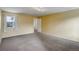 Bright bedroom featuring soft carpeting, natural light, and a neutral palette at 2466 S Vaughn Way # A, Aurora, CO 80014