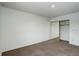 This bedroom has a large closet with mirrored doors, neutral carpeting, and bright natural light from the window at 2466 S Vaughn Way # A, Aurora, CO 80014