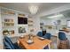 Bright open-concept dining room with white shelving, a wooden table, and access to the kitchen at 2466 S Vaughn Way # A, Aurora, CO 80014