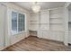 Bright dining room with a chandelier, large windows, and built in cabinets and shelving at 2466 S Vaughn Way # A, Aurora, CO 80014