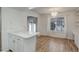 Bright dining area featuring wood-look flooring, modern chandelier, and sliding glass door access to the outside at 2466 S Vaughn Way # A, Aurora, CO 80014