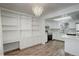 Eat-in kitchen featuring stainless steel appliances, white cabinets, modern backsplash, and built-in shelving at 2466 S Vaughn Way # A, Aurora, CO 80014