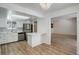 Eat-in kitchen featuring stainless steel appliances, white cabinets, and modern backsplash at 2466 S Vaughn Way # A, Aurora, CO 80014