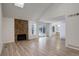 Spacious living room featuring a stone fireplace, vaulted ceilings, and sliding glass doors at 2466 S Vaughn Way # A, Aurora, CO 80014