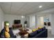 Cozy living room with plush seating, wooden furniture, a white rug, and an adjacent dining room space at 2466 S Vaughn Way # A, Aurora, CO 80014