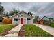 Gray house with red door, landscaped yard, and walkway at 725 Osceola St, Denver, CO 80204