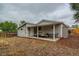 Rear view of house showing covered patio and fenced yard at 725 Osceola St, Denver, CO 80204