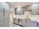 Modern kitchen with gray cabinets, stainless steel appliances and island at 725 Osceola St, Denver, CO 80204