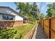 Home's backyard features a well-maintained lawn, a covered patio, and a privacy fence at 12475 W 38Th Ave, Wheat Ridge, CO 80033