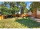 Large backyard with wooden fence and mature trees providing ample privacy at 12475 W 38Th Ave, Wheat Ridge, CO 80033