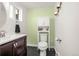 This bathroom features a modern sink and cabinet, a toilet, and decorative accents at 12475 W 38Th Ave, Wheat Ridge, CO 80033