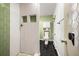 Modern bathroom with a walk-in shower, sleek black flooring, and a uniquely designed mirror at 12475 W 38Th Ave, Wheat Ridge, CO 80033
