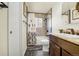 Well-lit bathroom with a shower-tub, with stylish tile work and a modern vanity at 12475 W 38Th Ave, Wheat Ridge, CO 80033
