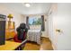 Cozy bedroom with warm wood floors, a comfortable bed, and a sunlit window view at 12475 W 38Th Ave, Wheat Ridge, CO 80033