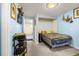 Inviting bedroom with gray carpet, a built-in closet, and featuring stylish blue walls at 12475 W 38Th Ave, Wheat Ridge, CO 80033