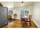A dining area features a dining table and a sliding glass door to the backyard at 12475 W 38Th Ave, Wheat Ridge, CO 80033