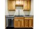 The kitchen features wood cabinets, granite countertops, and stainless steel appliances at 12475 W 38Th Ave, Wheat Ridge, CO 80033