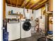 A utilitarian laundry room features an updated washer and dryer, plus a utility sink at 12475 W 38Th Ave, Wheat Ridge, CO 80033