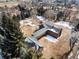 Aerial view of brown two-story home with glass enclosed walkway connecting the two buildings at 3720 E Quincy Ave, Cherry Hills Village, CO 80113