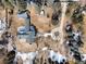 Aerial view of a home with a circle driveway surrounded by mature trees at 3720 E Quincy Ave, Cherry Hills Village, CO 80113