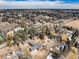 Aerial view of the property showing surrounding trees, a pool on a neighboring property, and lush landscape at 3720 E Quincy Ave, Cherry Hills Village, CO 80113