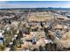 Aerial shot showcasing a large lot near a football field, trees and city skyline in the distance at 3720 E Quincy Ave, Cherry Hills Village, CO 80113