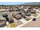 Aerial view of a neighborhood with manicured lawns, sidewalks, and a scenic mountain backdrop at 17855 Lake Side Dr, Monument, CO 80132