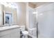 Bathroom featuring a single sink, shower stall, and white cabinets offering a clean, modern aesthetic at 17855 Lake Side Dr, Monument, CO 80132