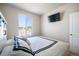 Modern bedroom with a comfortable bed, mounted TV, and a large window offering plenty of natural light at 17855 Lake Side Dr, Monument, CO 80132