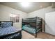 Comfortable bedroom featuring bunk beds with patterned bedding, carpet flooring, and bright window views at 17855 Lake Side Dr, Monument, CO 80132
