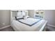 Bright bedroom featuring a comfortable bed with a decorative headboard and view from a window at 17855 Lake Side Dr, Monument, CO 80132